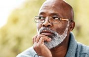 An older gentleman is thinking