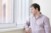 A man is looking out through the window