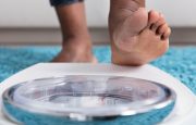 A person is about to step on a weight scale