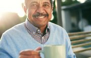 A man is holding a cup of coffee