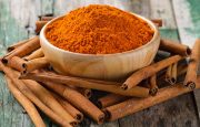 A bowl of cinnamon and cinnamon sticks