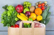 Grocery bag filled with various fruits and vegetables