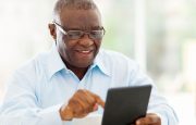 A man is reading on his tablet