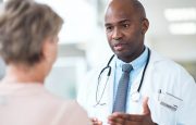 Male doctor talking to a female patient in the hospital corridor